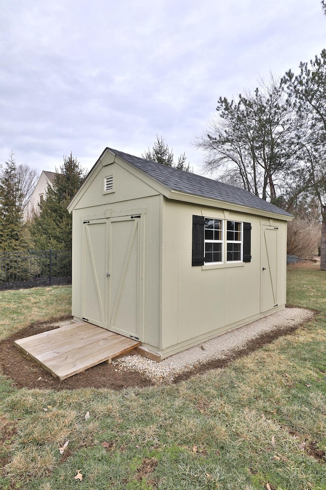 view of outbuilding with a lawn