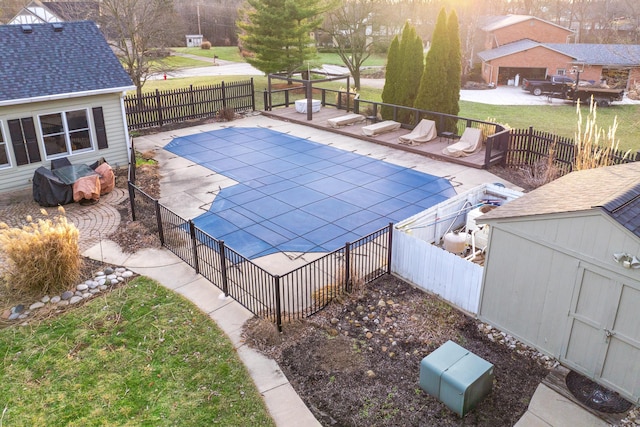 view of pool with a storage unit and a patio area