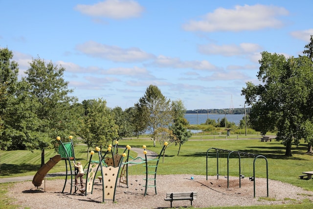 surrounding community with a playground, a water view, and a yard