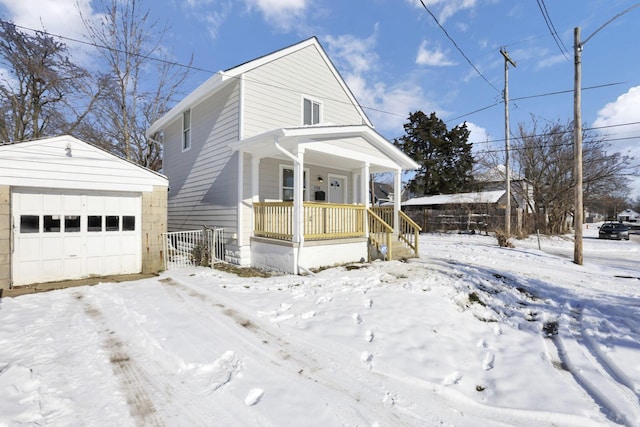 view of front facade featuring an outbuilding, covered porch, and a garage