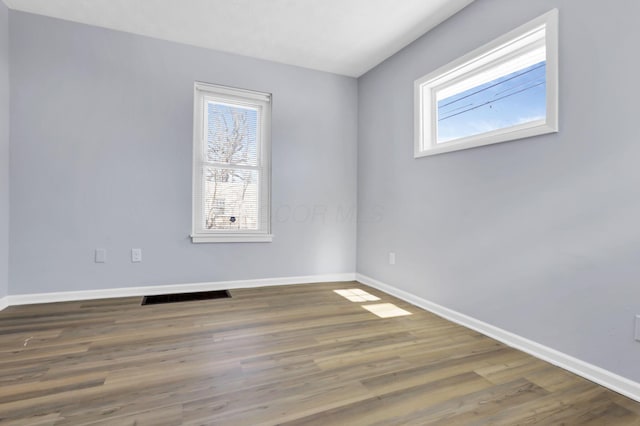 spare room with dark wood-type flooring