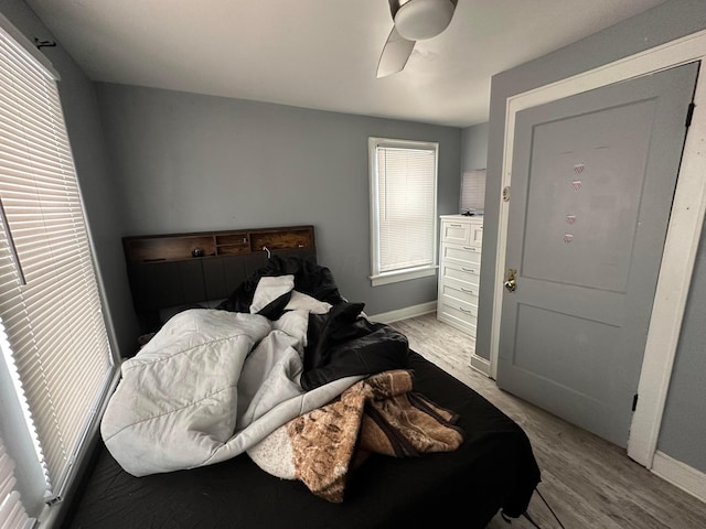 bedroom with ceiling fan and light hardwood / wood-style floors