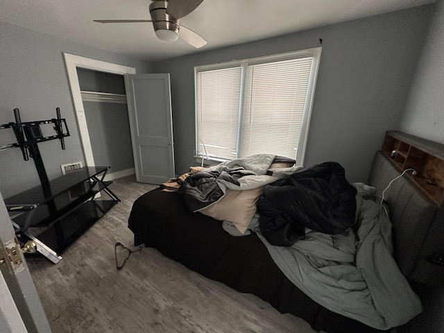 bedroom featuring ceiling fan, a closet, and light hardwood / wood-style floors