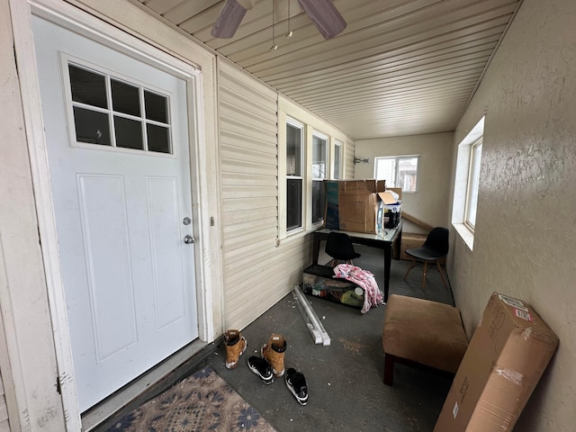 property entrance with ceiling fan