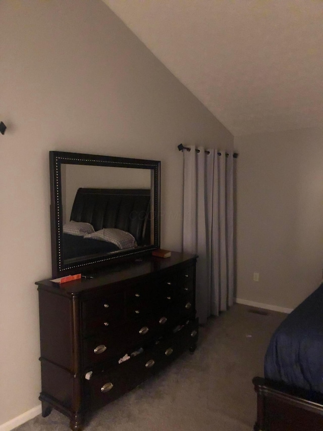 carpeted bedroom featuring lofted ceiling