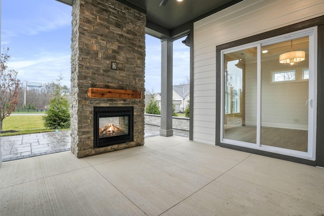 view of patio / terrace featuring an outdoor stone fireplace