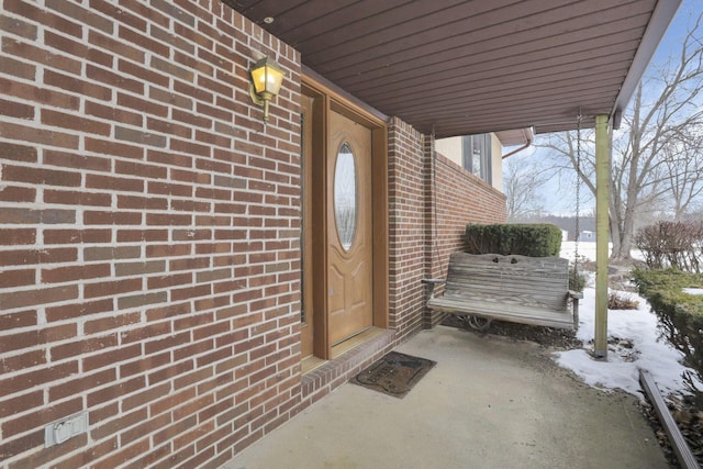 view of snow covered property entrance