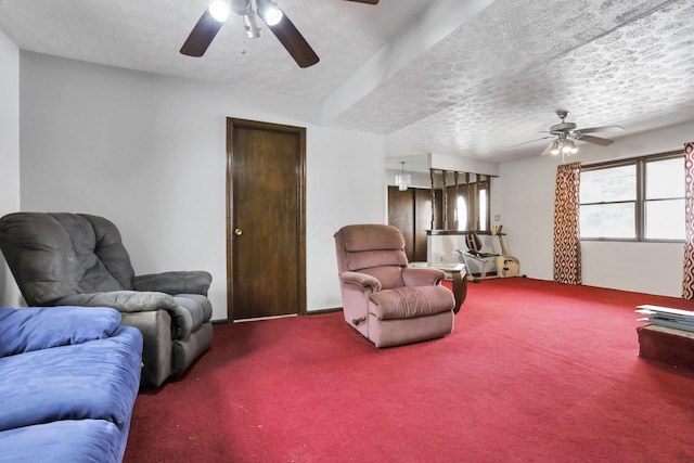 carpeted living room featuring ceiling fan and a textured ceiling