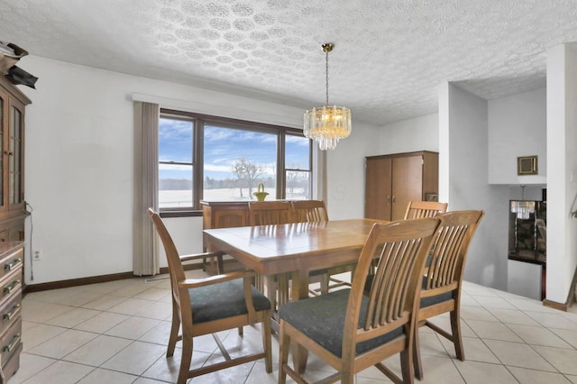 tiled dining room with an inviting chandelier