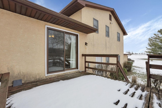 view of snow covered property entrance