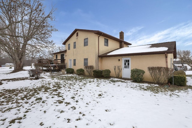 snow covered property featuring a deck