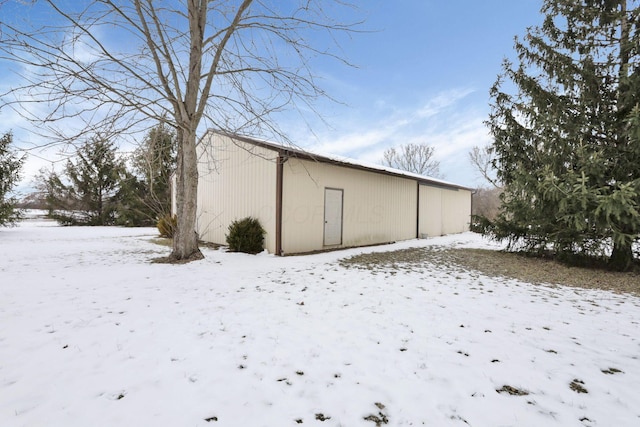 view of snow covered rear of property