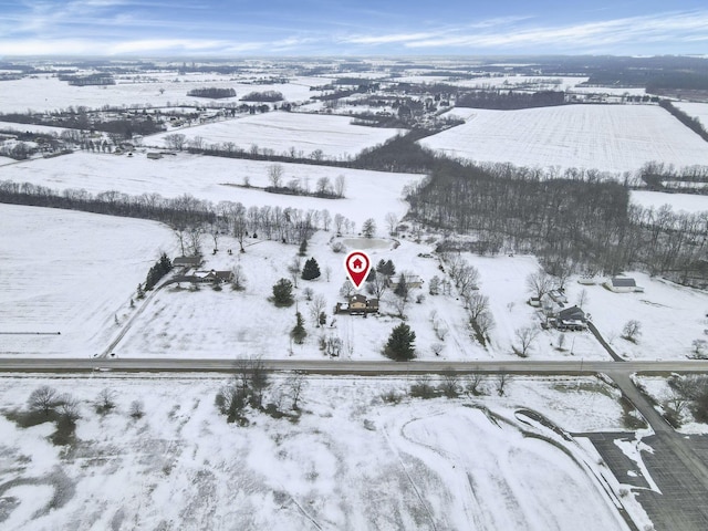 snowy aerial view featuring a rural view