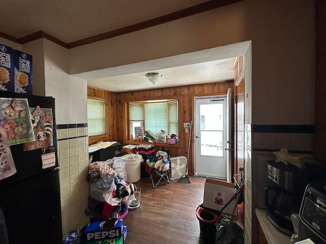 misc room featuring wooden walls, crown molding, and hardwood / wood-style flooring