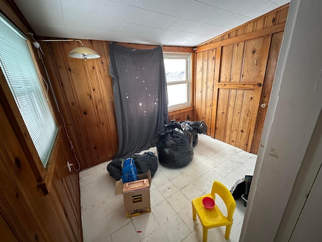 bedroom featuring wooden walls