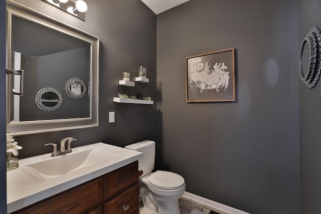 bathroom with tile patterned floors, vanity, and toilet