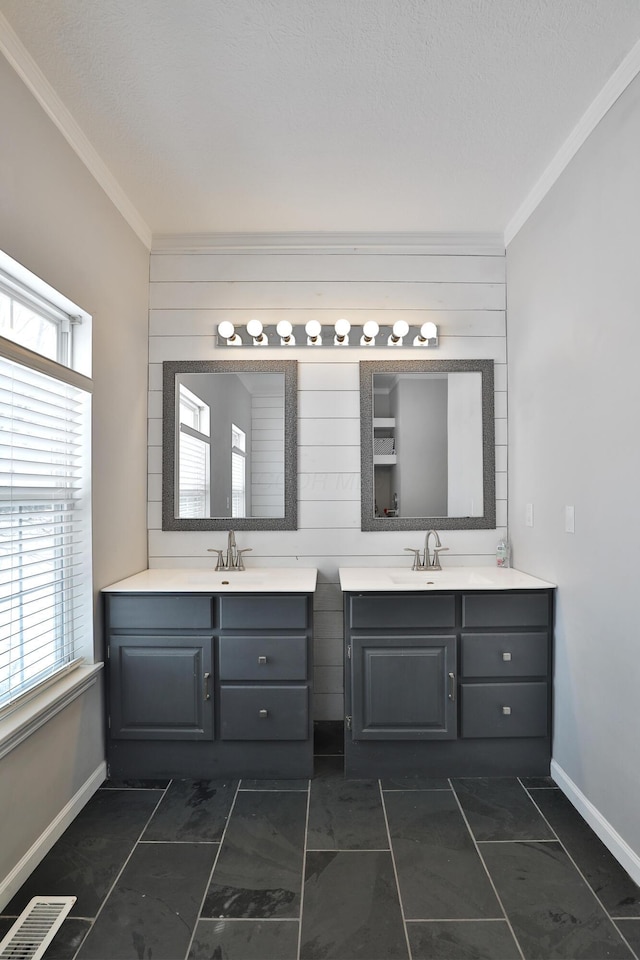 bathroom featuring tile patterned flooring, wood walls, ornamental molding, and vanity