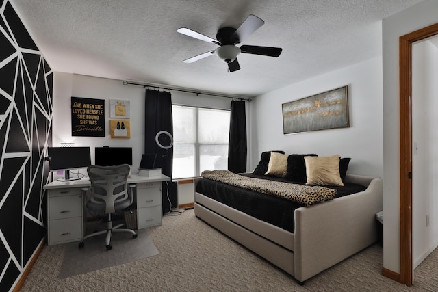 bedroom featuring ceiling fan, carpet, and a textured ceiling