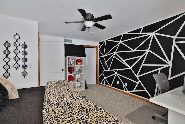 bedroom with a closet, carpet floors, ceiling fan, and a textured ceiling