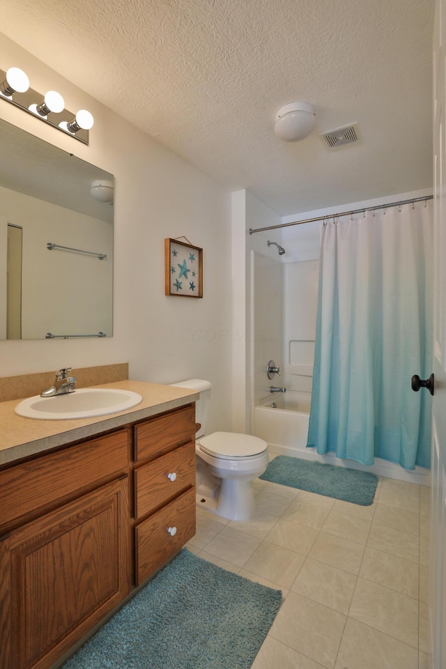 full bathroom with toilet, vanity, a textured ceiling, and shower / bath combo with shower curtain