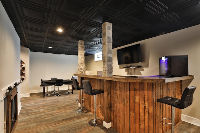 bar with refrigerator and hardwood / wood-style floors