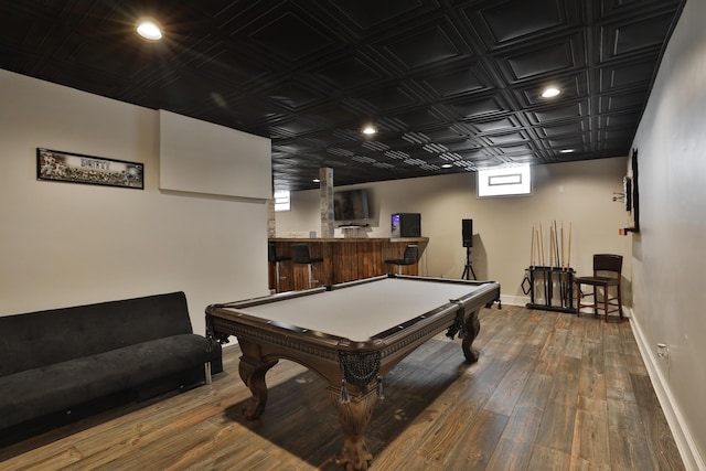 game room featuring pool table, bar, and hardwood / wood-style floors