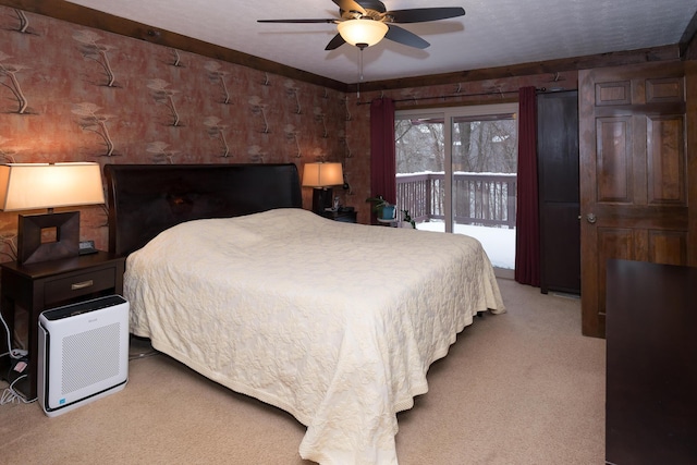 carpeted bedroom with ceiling fan and access to outside