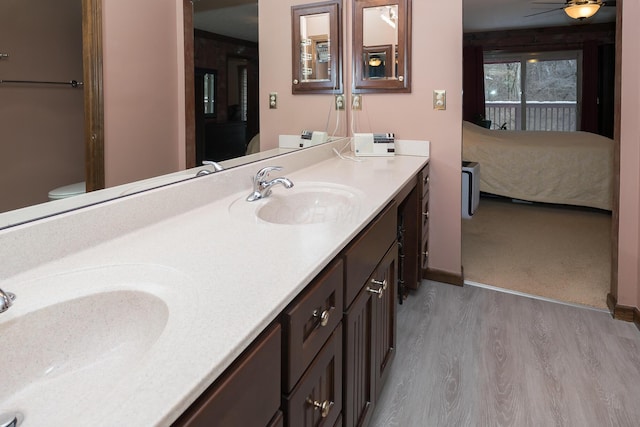 bathroom with ceiling fan, vanity, toilet, and hardwood / wood-style flooring