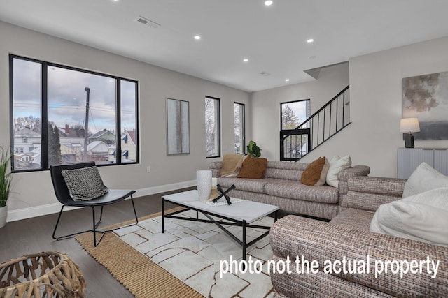 living room featuring recessed lighting, visible vents, baseboards, and wood finished floors