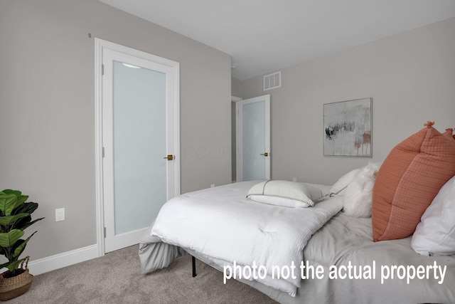 carpeted bedroom featuring visible vents and baseboards