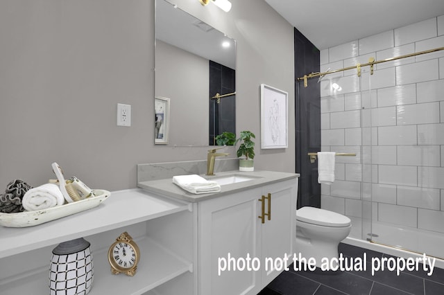 full bath featuring vanity, a shower stall, toilet, and tile patterned floors