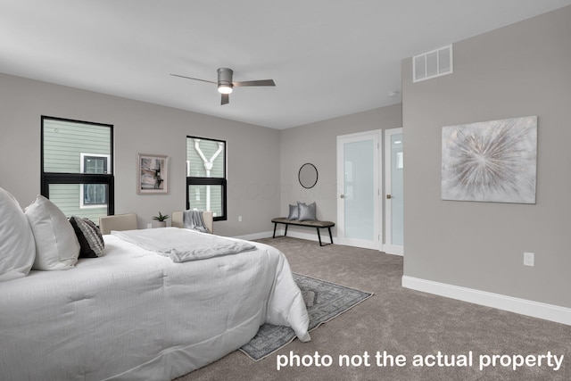 carpeted bedroom with baseboards, visible vents, and a ceiling fan