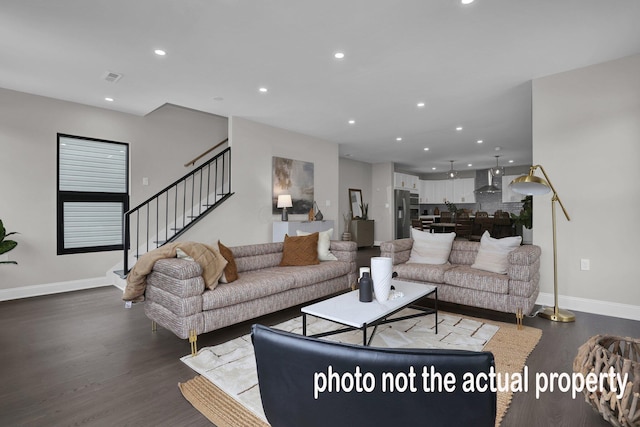 living area featuring stairs, baseboards, wood finished floors, and recessed lighting