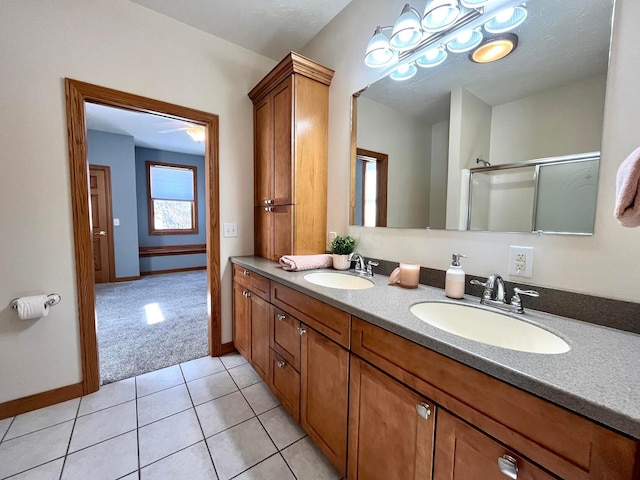 bathroom featuring tile patterned floors, vanity, and walk in shower