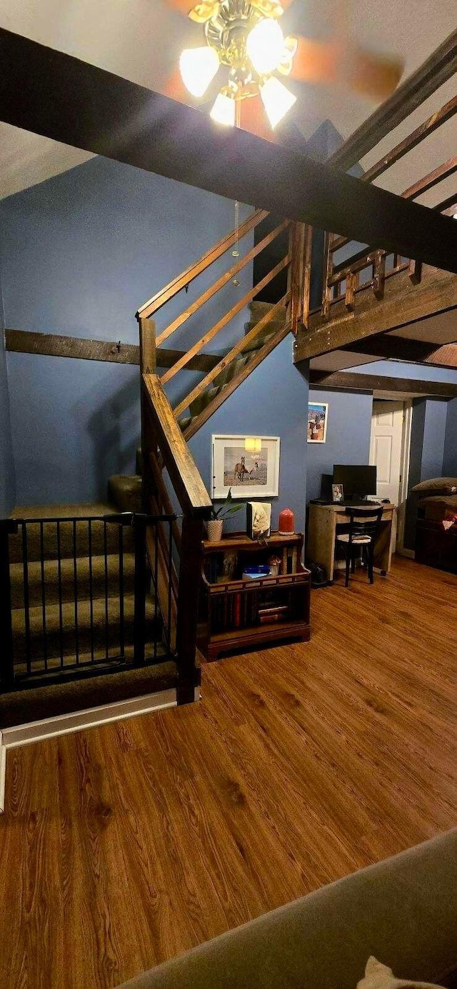 stairway with hardwood / wood-style floors and ceiling fan