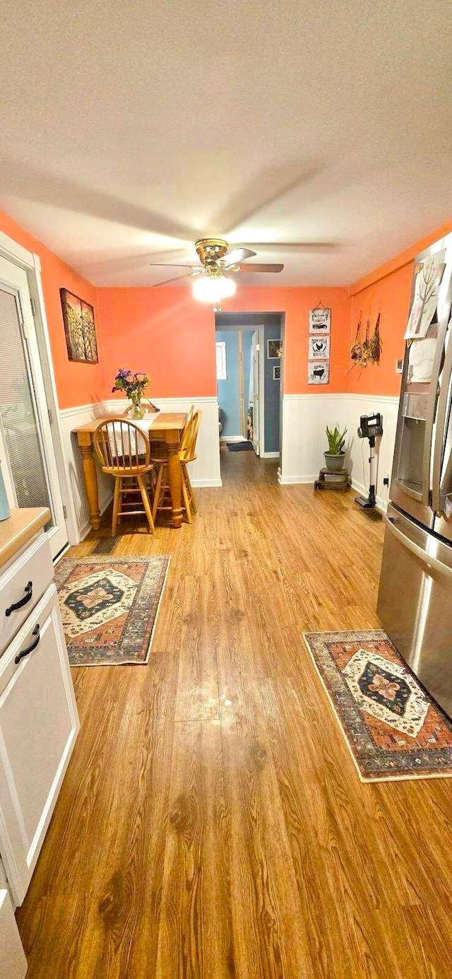 dining area with a textured ceiling and light hardwood / wood-style flooring