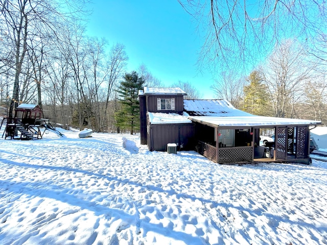 snow covered property with board and batten siding