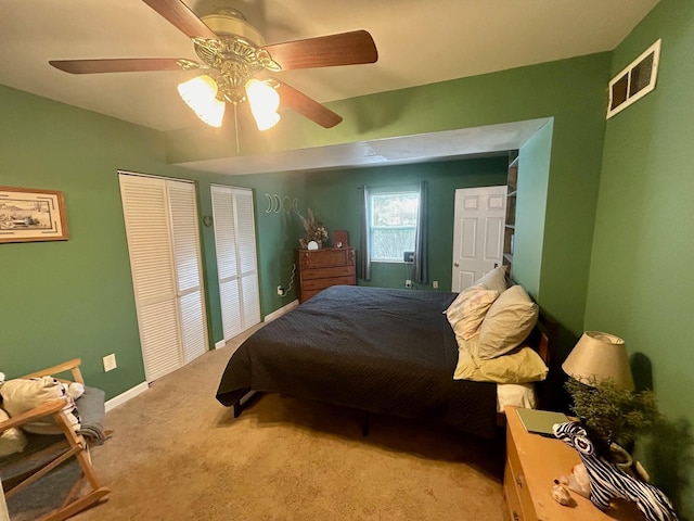 bedroom with baseboards, visible vents, ceiling fan, and light colored carpet