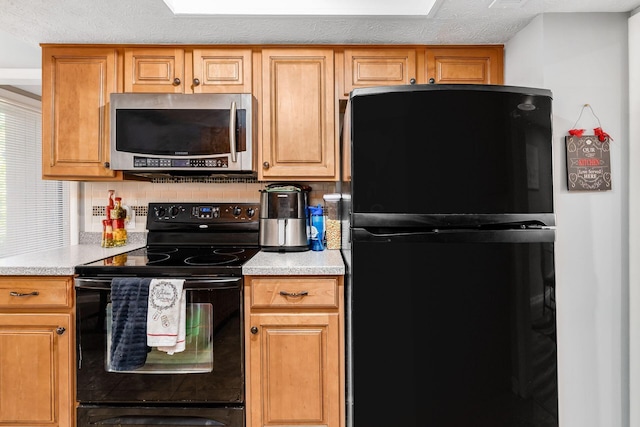 kitchen with black appliances, a textured ceiling, and tasteful backsplash