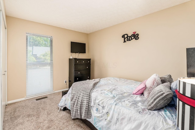 bedroom featuring light colored carpet