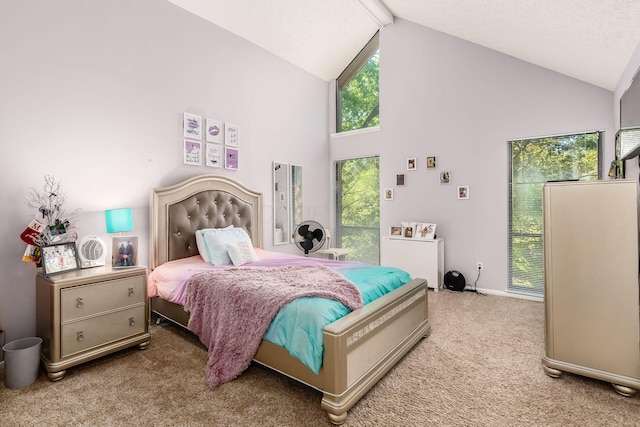 carpeted bedroom featuring high vaulted ceiling and multiple windows