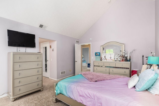 bedroom featuring light carpet and vaulted ceiling