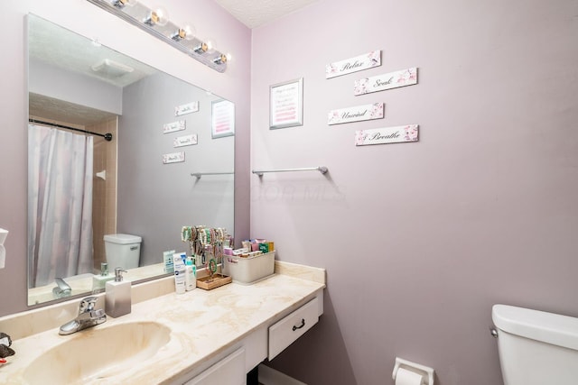 bathroom with a shower with curtain, vanity, and toilet