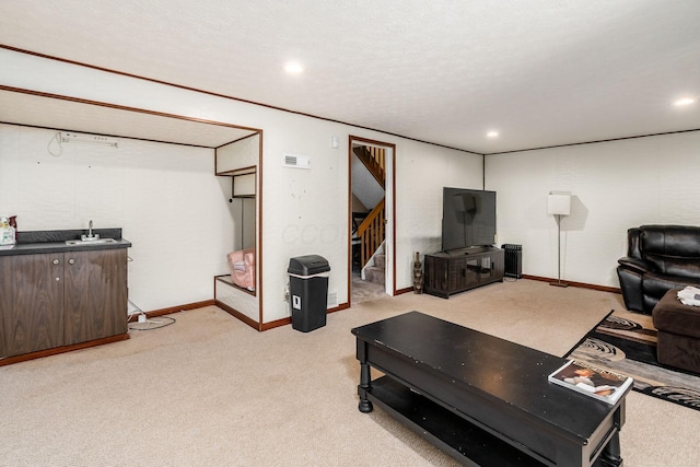 carpeted living room featuring a textured ceiling