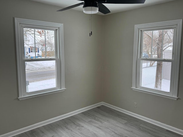 spare room with ceiling fan and wood-type flooring