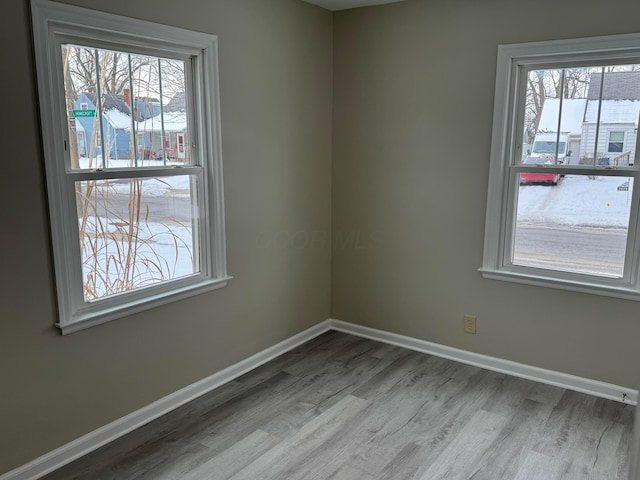 spare room featuring light wood-type flooring