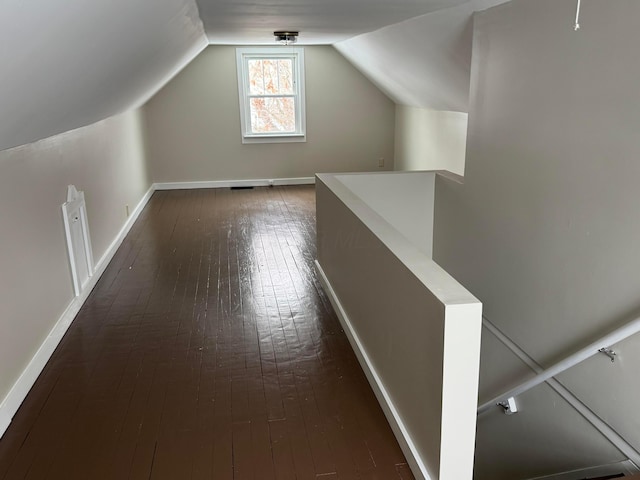 bonus room with dark hardwood / wood-style flooring and lofted ceiling