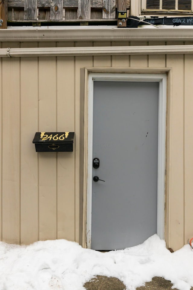 view of snow covered property entrance