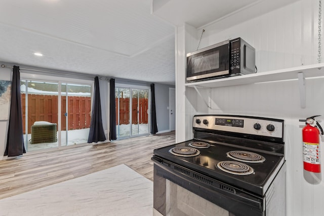 kitchen featuring black / electric stove and wood-type flooring