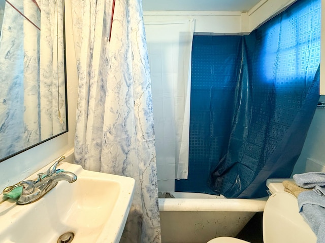 bathroom with sink, a shower with curtain, and toilet